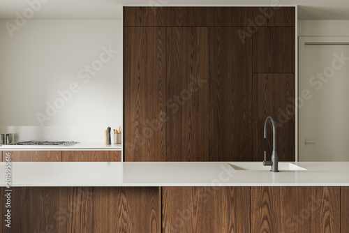 Photos Modern minimalist kitchen interior featuring warm wooden cabinetry, sleek white countertops, and refined architecture in a serene contemporary design concept