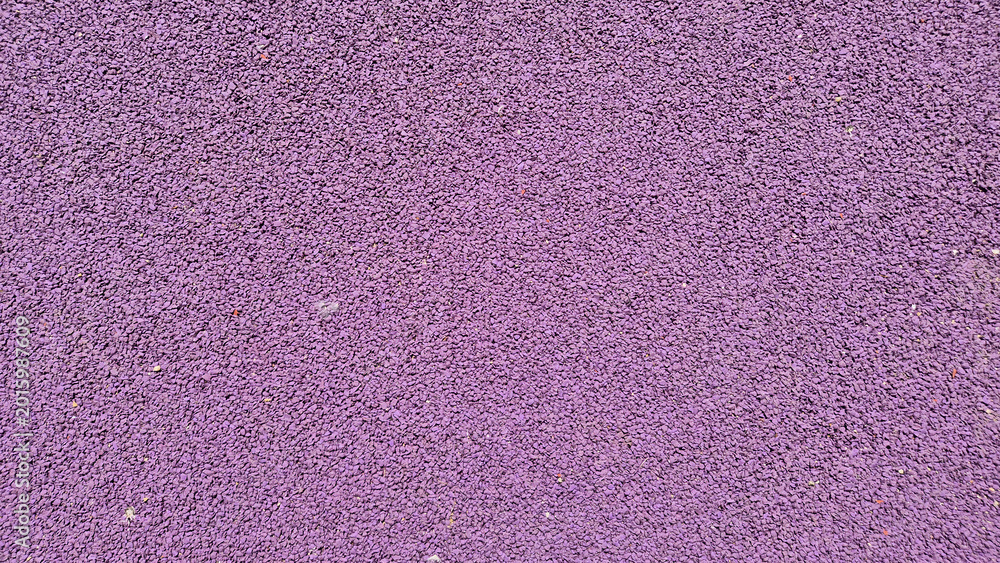 Fototapeta premium A high-angle, full-frame shot of a textured purple EPDM rubber crumb surface, commonly used for playground safety flooring or athletic tracks to provide impact absorption.