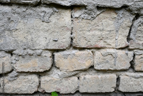 Photos Weathered, deteriorated wall in urban setting, representing economic hardship, housing challenges, and societal struggles during a cost of living crisis