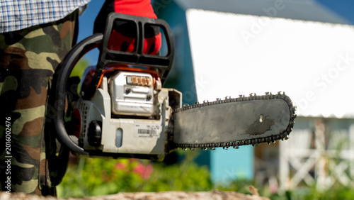 Photos Person grips chainsaw firmly, ready for work