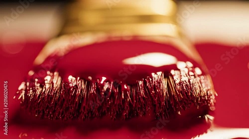 Macro closeup of a paint brush loaded with thick red paint, dripping fluid over a wet surface, abstract texture, creative visual