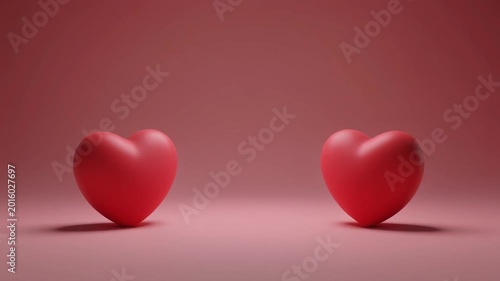 Two minimalist red hearts on a soft pink background, symbolizing love and romance