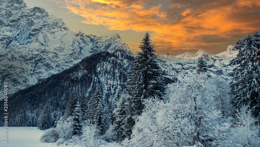 Fototapeta premium a polar cold and a beautiful winter scene with the sunset behind the mountains