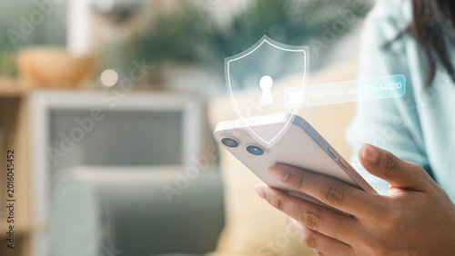 Tableau sur toile User holding smartphone with security shield and OTP code interface, representing two factor authentication, login protection, mobile cybersecurity and secure digital identity verification