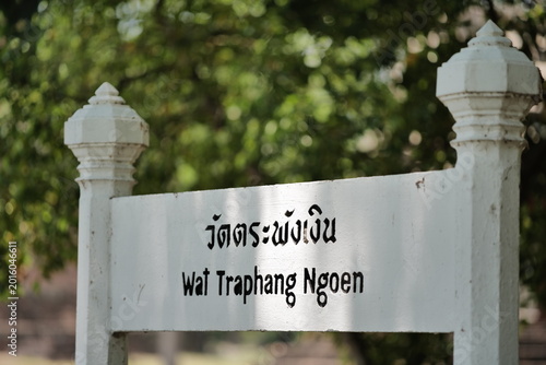 Bild auf Leinwand Ancient seated Buddha statue surrounded by green trees at Wat Mahathat, Sukhothai Historical Park, Thailand