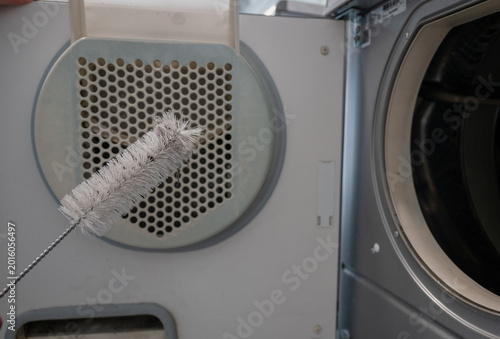 Konstfotografi Cleaning dryer vent filter with dust buildup in laundry machine close up