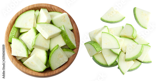 sliced zucchini or marrow in wooden bowl isolated on white background. clipping path