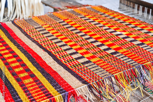 Obraz na plátně colorful handwoven textile on traditional loom close up