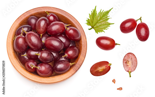 red grapes berries in wooden bowl isolated on white background. clipping path