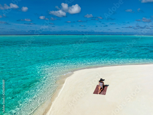 Paradise beaches of the Maldives. Tourism, travel and vacation in a luxury resort. Woman in bikini on the background of the sea and the beach