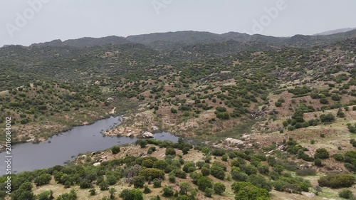 Beautiful Drone Footage of Historic Rock Landscapes and Serene Lake