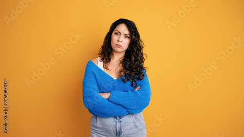 Tableau sur toile Woman standing with arms crossed, frowning her face, showing disappointment, ann