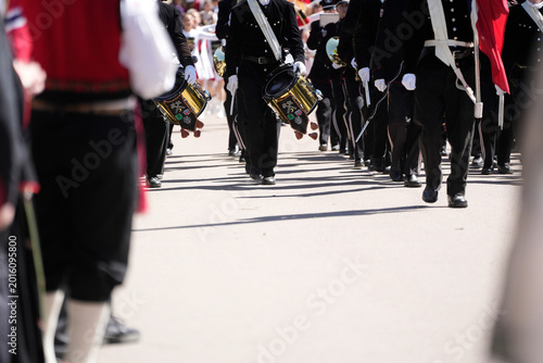 Golden Snare Drums and Black Uniforms – Marching Band in Formation on Sunlit Parade Street During Norwegian National Day