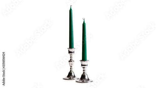 Tableau sur toile Two tall green taper candles in ornate silver candlesticks, isolated on transpar