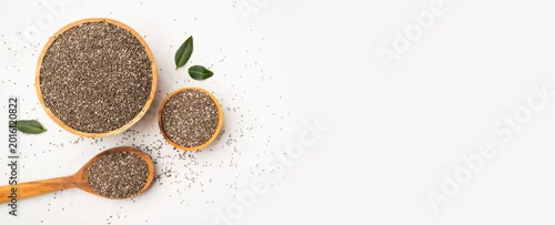 Panel kuchenny z motywem Organic chia seeds in wooden bowl and spoon on white background, top view. Superfood, source of omega-3 fatty acids and fiber. Healthy dried seeds of Salvia hispanica plant