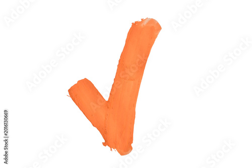 A stroke of orange acrylic paint in the shape of a check mark on a white background.