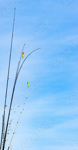 Fotografia fishing rods against blue sky