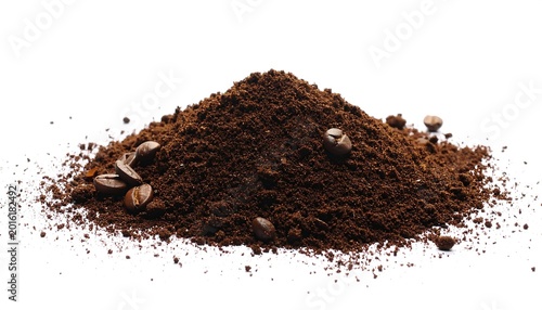 A mound of dark brown coffee grounds, with whole coffee beans scattered around