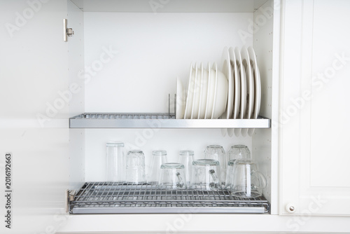Photos A kitchen cabinet with shelves