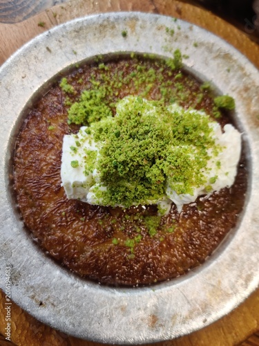 Delicious Turkish desserts including crispy kunafa, sweet baklava, creamy ice cream, and fresh pistachios served in Istanbul, Turkey with authentic Middle Eastern flavors.