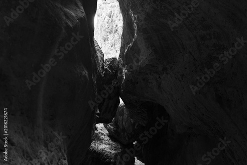 View from inside the narrow Karadakh Gorge with towering rock walls and a bright opening above, natural canyon landmark in Dagestan, Russia, travel nature scenery