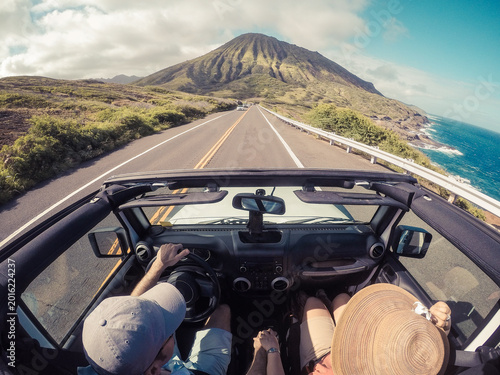 Overhead view of a couple driving along a coastal road in a convertible car, Lahaina, Maui, Hawaii, USA