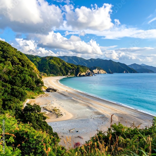 Tropical Coast Landscape Photography With Turquoise Sea Water And Sandy Beach Under A Blue Cloudy And Lush Green Mountains In The Distance