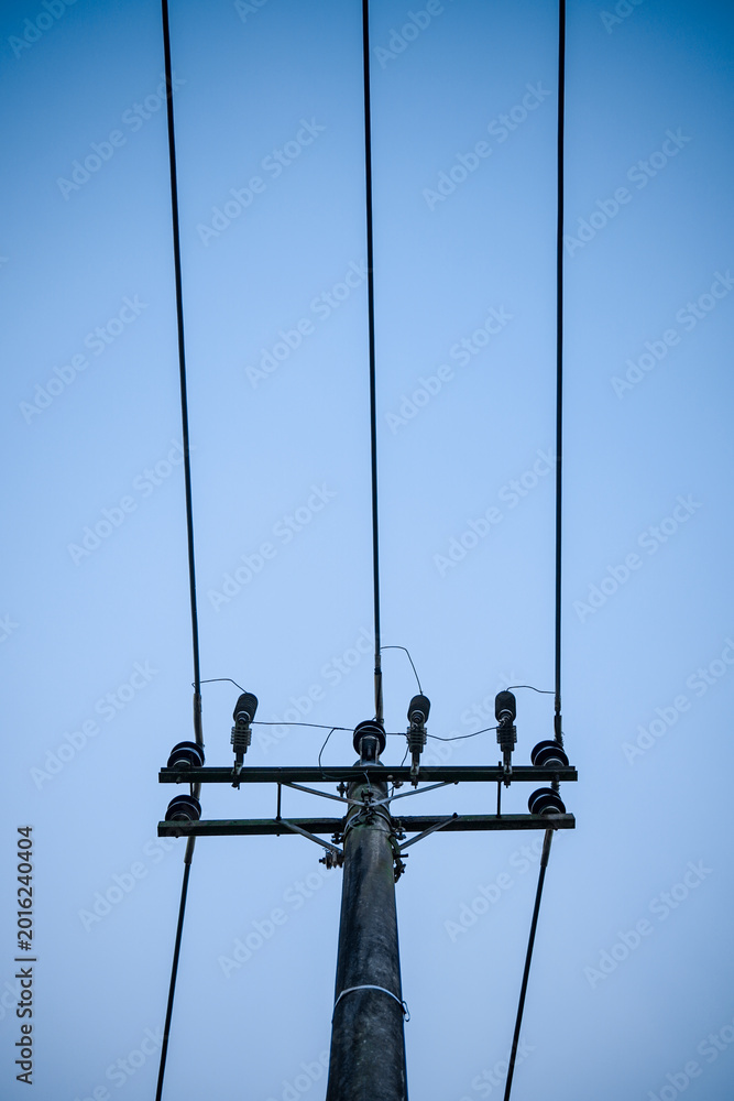 Obraz premium Power Lines And Utility Pole Against Clear Blue Sky Minimalist Electrical Infrastructure