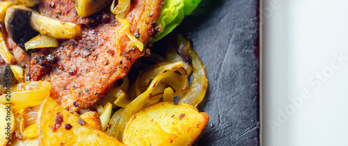 Photos Grilled pork chop rests atop crisp lettuce