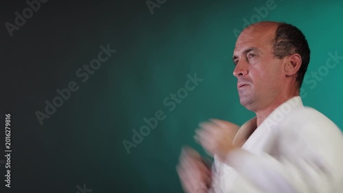 A young athlete practices punching against a multi-colored background with flashing red and green lights