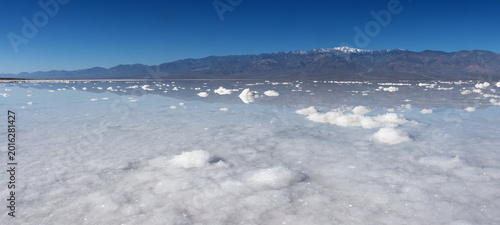 Reflection of sky on the flooded salt flats of Badwater Basin in Death Valley National Park.