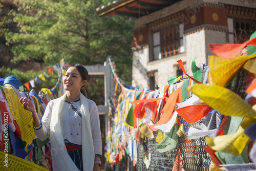 Tableau sur toile Tourist or Traditional Bhutanese suspension bridge adorned with vibrant prayer f