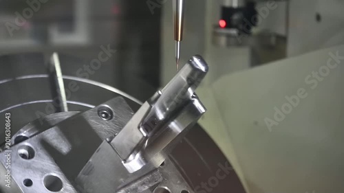 Slow motion clip of a high-precision 5-axis CNC milling machine performing a finish cut on complex mold parts.