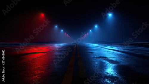 Empty road at night with red and blue streetlights reflecting on wet asphalt