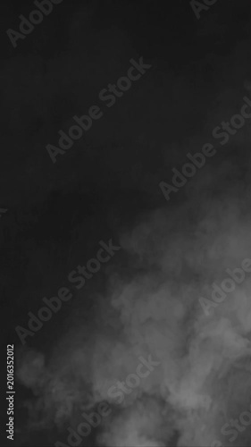 Atmospheric white smoke billowing upwards against a dark black background in vertical format.