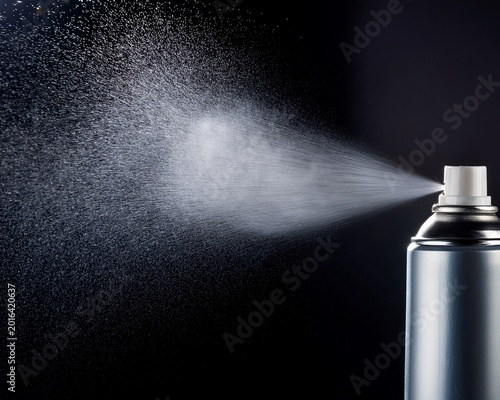 aerosol bottle spray can mist closeup on dark black background