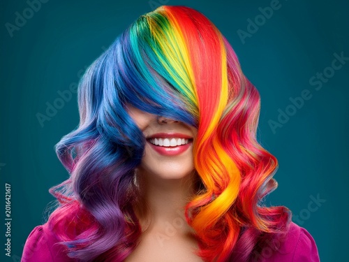funny multicolor wavy hair woman portrait isolated on one color background. artistic abstract image.