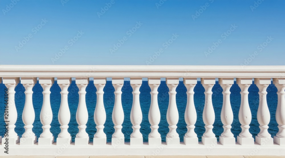 Naklejka premium White balustrade overlooks calm blue ocean and clear sky. Classic railing provides a serene view of the sea and coast. Peaceful waterfront terrace offers perfect vacation spot.
