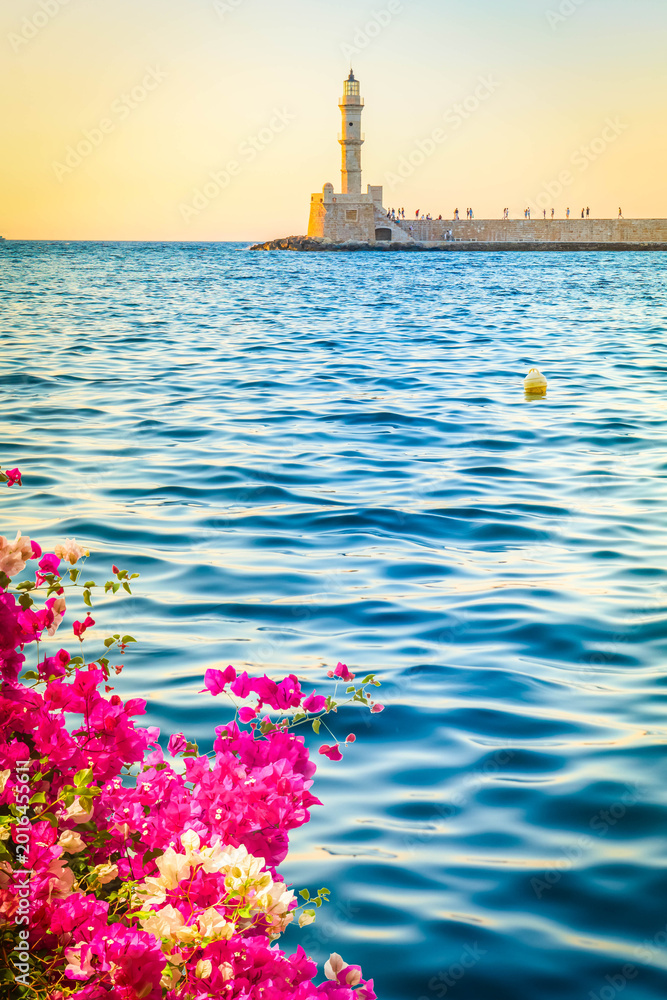 Fototapeta premium bay of Chania with sea and lighthouse at sunny summer sunset, Crete, Greece, web banner format