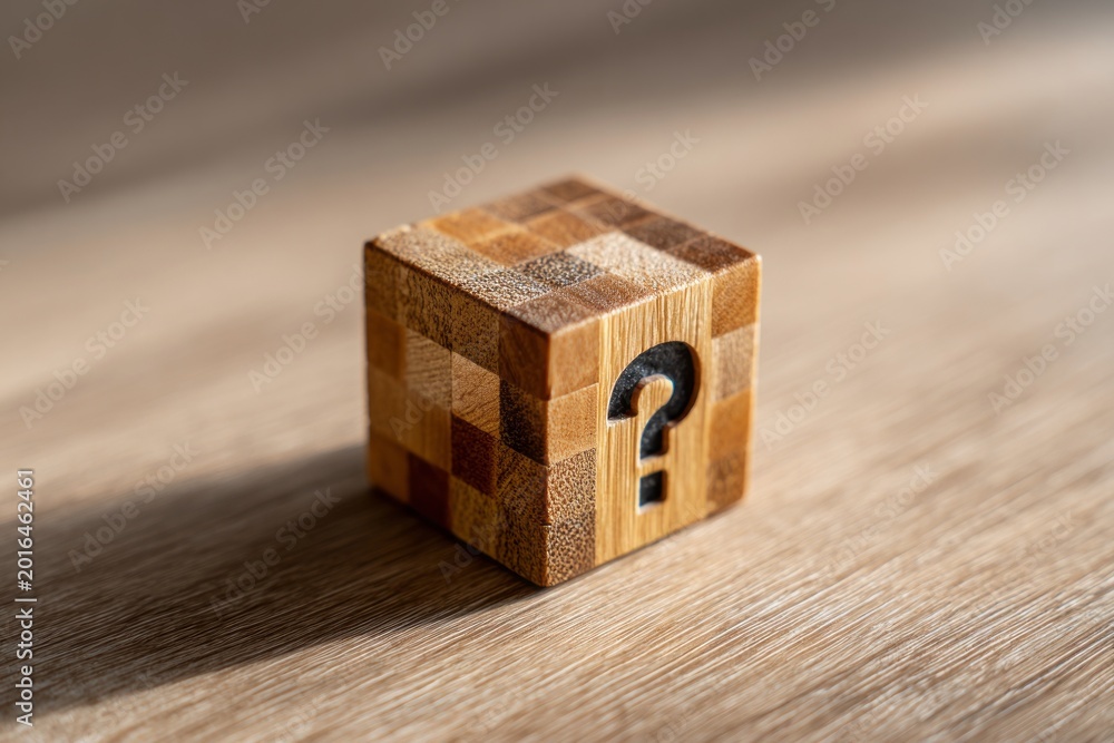 Obraz premium a question mark block wooden cube background with space for text, Wooden block featuring a question mark.
