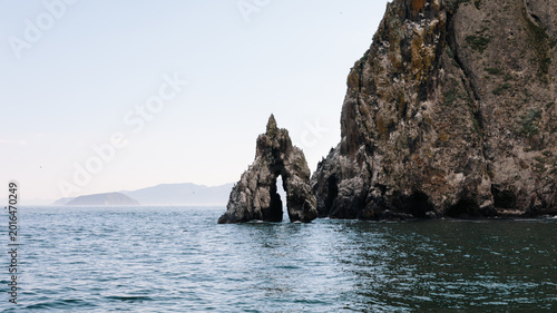 Photos Coastal landscape of Avacha Bay with rugged sea cliffs and a natural rock arch a