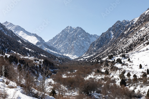Fotografía Panoramic winter view of Issyk-Ata Gorge with rugged snow-covered mountains, for