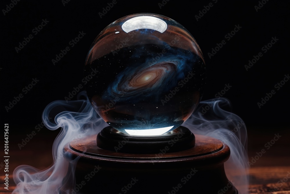 Fototapeta premium Crystal ball rests on wooden stand showing galaxy within. Wisps of smoke curl around sphere. Represents future telling astrology mysticism or scientific discovery concept.