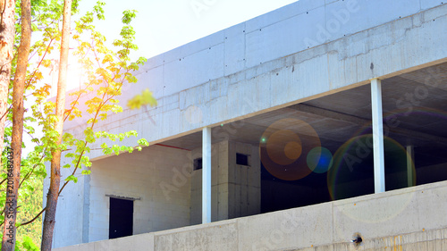Slika na platnu An abandoned concrete building under construction surrounded by a forest
