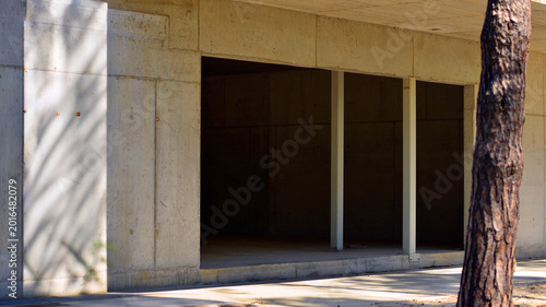 Canvas Print An abandoned concrete building under construction surrounded by a forest