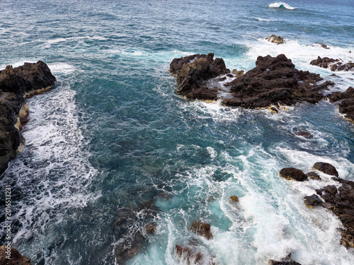 Ocean Waves Breaking Around Rocky Shoreline
