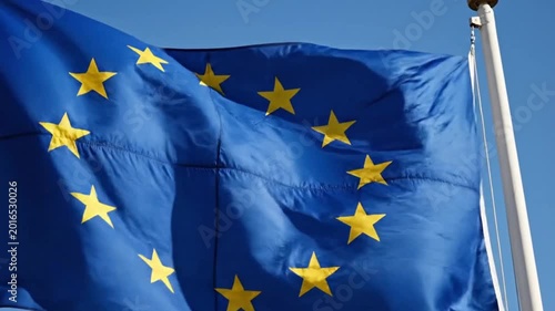 The flag of the european union waving against a clear blue sky