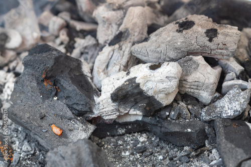 Burning charcoal briquettes glowing red for grilling food