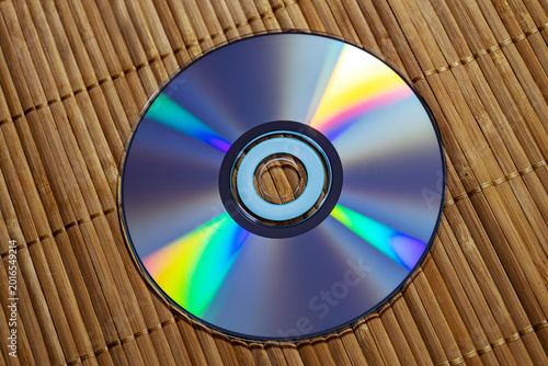 A DVD lies on a wooden surface. Top view