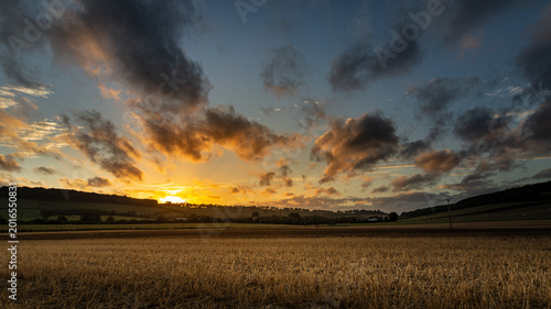 Tableau sur toile Dramatic HDR sunset clouds over a harvested field in Meon Valley